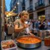 Mujer utilizando la batidora de brazo HB02 para triturar una salsa de tomate y verduras directamente en una olla grande de cocina.