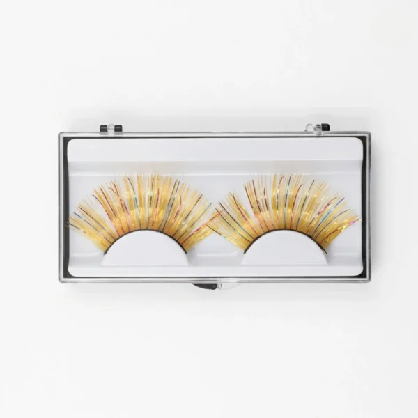 Caja de pestañas postizas de oropel dorado con brillo multicolor en estuche transparente protector para almacenamiento.