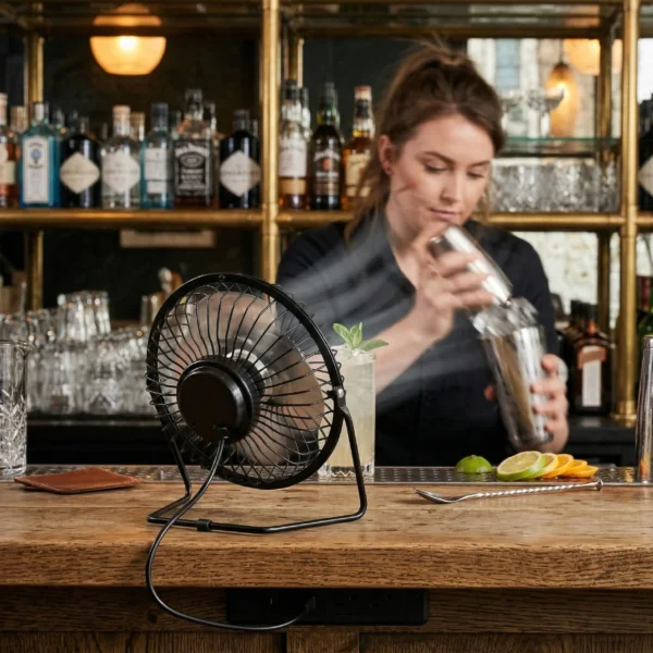 Mini ventilador USB de metal en una barra de bar profesional, ideal para espacios compactos y hostelería.