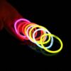 Pulseras fluorescentes Lumi Flex encendidas sobre una mesa en ambiente nocturno durante una fiesta