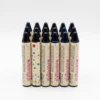 Lote de barras de maquillaje en stick tono negro intenso con diseño de puntos de colores, ideal para uso profesional y personal.